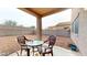 Spacious backyard patio with seating, offering a relaxing outdoor living space and gravel landscaping at 16807 W Carmen Dr, Surprise, AZ 85388