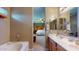 Open bathroom featuring a tub, vanity and a view into the main bedroom at 16807 W Carmen Dr, Surprise, AZ 85388