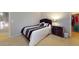A cozy bedroom features a bed with decorative pillows, a dresser, and access to a closet at 16807 W Carmen Dr, Surprise, AZ 85388