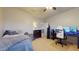 Bedroom features a comfortable bed and a dedicated gaming setup with multiple monitors at 16807 W Carmen Dr, Surprise, AZ 85388