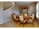 Formal dining room with an elegant wooden table, six chairs, china cabinet, and natural light at 16807 W Carmen Dr, Surprise, AZ 85388