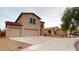 Beautiful two-story home with a two-car garage and spacious driveway, with desert landscaping at 16807 W Carmen Dr, Surprise, AZ 85388