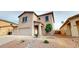 Charming two-story home featuring a neutral color palette, a two-car garage, and low-maintenance landscaping at 16807 W Carmen Dr, Surprise, AZ 85388