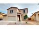 Inviting two-story home featuring a neutral color scheme, desert landscaping, and a convenient two-car garage at 16807 W Carmen Dr, Surprise, AZ 85388