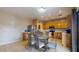 Bright kitchen and breakfast nook featuring tile floors, wooden cabinetry, and a stainless steel refrigerator at 16807 W Carmen Dr, Surprise, AZ 85388
