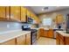 Bright kitchen featuring stainless steel appliances, ample counter space, and warm-toned wood cabinets at 16807 W Carmen Dr, Surprise, AZ 85388