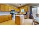 Spacious kitchen with stainless steel appliances, tile flooring, a kitchen island, and plenty of cabinet space at 16807 W Carmen Dr, Surprise, AZ 85388