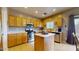Open concept kitchen with tile floors, stainless appliances, kitchen island, and lots of cabinet space at 16807 W Carmen Dr, Surprise, AZ 85388