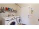 Well-lit laundry room featuring a modern, front-loading Samsung washer and dryer set at 16807 W Carmen Dr, Surprise, AZ 85388