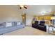 Open-concept living space offering comfortable seating, a ceiling fan, and easy access to the kitchen at 16807 W Carmen Dr, Surprise, AZ 85388