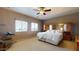 Spacious main bedroom with an attached wardrobe and two windows providing natural light at 16807 W Carmen Dr, Surprise, AZ 85388