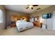 Comfortable main bedroom with a king bed, mirrored closet, ceiling fan, and a relaxing atmosphere at 16807 W Carmen Dr, Surprise, AZ 85388
