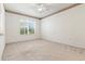 A bedroom with neutral carpet, fan and big window giving natural light at 1747 E Northern Ave # 104, Phoenix, AZ 85020