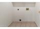 Clean laundry room area with tile flooring and hookups for appliances at 1747 E Northern Ave # 104, Phoenix, AZ 85020