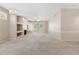 Spacious living room with a decorative fireplace, neutral carpet and abundant natural light at 1747 E Northern Ave # 104, Phoenix, AZ 85020