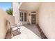 Private patio with chairs, outdoor lighting and security door in a neutral color palette at 1747 E Northern Ave # 104, Phoenix, AZ 85020