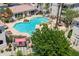 Community pool area with lounge chairs, umbrellas, tables, BBQ and lush landscaping at 1747 E Northern Ave # 104, Phoenix, AZ 85020