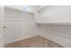 Well-lit walk-in closet with shelving and carpet flooring at 1747 E Northern Ave # 104, Phoenix, AZ 85020