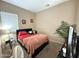 Cozy bedroom with neutral walls, carpeted floors, and a window offering natural light at 2014 N 93Rd Dr, Phoenix, AZ 85037