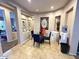 Cozy dining area featuring a round glass table, blue chairs, and elegant decor at 2014 N 93Rd Dr, Phoenix, AZ 85037