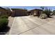 Charming single-Gathering home featuring a well-manicured front yard with xeriscape and a two-car garage at 2014 N 93Rd Dr, Phoenix, AZ 85037