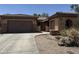 Charming single-Gathering home featuring a well-manicured front yard with xeriscape and a two-car garage at 2014 N 93Rd Dr, Phoenix, AZ 85037