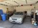 Functional two-car garage with ample storage space, and a vehicle parked inside at 2014 N 93Rd Dr, Phoenix, AZ 85037