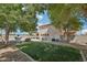 Large backyard with a view of the home and pool, surrounded by mature trees at 2061 E Flintlock Way, Chandler, AZ 85286
