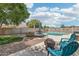 Expansive backyard with lush lawn, inviting pool, mature trees and comfortable seating at 2061 E Flintlock Way, Chandler, AZ 85286