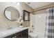 Bathroom with combined shower-tub, large mirror, and floral decoration at 2061 E Flintlock Way, Chandler, AZ 85286