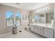 Bright bathroom with a dual sink vanity and natural light from two windows at 2061 E Flintlock Way, Chandler, AZ 85286