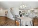 Cozy dining area adjacent to the kitchen with natural light, wood floors, and views of the staircase at 2061 E Flintlock Way, Chandler, AZ 85286