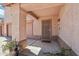 A welcoming covered front porch with security door and desert landscaping adds curb appeal to this charming home at 2061 E Flintlock Way, Chandler, AZ 85286