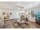 Bright living room features wood flooring, modern ceiling fan, and comfortable seating, creating an inviting atmosphere at 2061 E Flintlock Way, Chandler, AZ 85286