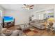 Bright living room features wood flooring, modern ceiling fan, and comfortable seating, creating an inviting atmosphere at 2061 E Flintlock Way, Chandler, AZ 85286