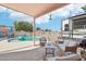 Covered patio with outdoor furniture overlooking sparkling pool and spacious backyard at 2061 E Flintlock Way, Chandler, AZ 85286