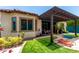 Inviting backyard with artificial turf, covered patio and desert landscaping, perfect for relaxing at 20962 W Thomas Rd, Buckeye, AZ 85396