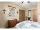 Cozy bedroom with wooden dresser and decorations creates a comforting and inviting atmosphere at 20962 W Thomas Rd, Buckeye, AZ 85396