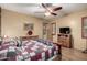 Comfortable bedroom with a ceiling fan, dresser, and TV, providing a cozy and functional space at 20962 W Thomas Rd, Buckeye, AZ 85396