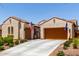 Charming home with tile roof, well-maintained landscaping, and a spacious driveway leading to a two-car garage at 20962 W Thomas Rd, Buckeye, AZ 85396
