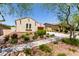 Inviting single-story home featuring a tile roof, well-maintained landscaping, and a wide driveway leading to a garage at 20962 W Thomas Rd, Buckeye, AZ 85396