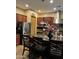 Beautiful kitchen with a stainless steel refrigerator, granite countertops, and an island with bar stool seating at 20962 W Thomas Rd, Buckeye, AZ 85396