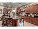 Spacious kitchen featuring wooden cabinets, granite countertops, stainless steel appliances, and a functional center island at 20962 W Thomas Rd, Buckeye, AZ 85396