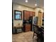 Kitchen view featuring stainless steel refrigerator, granite countertop, and brown cabinets at 20962 W Thomas Rd, Buckeye, AZ 85396
