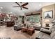 Open-concept living room showcasing tile flooring, recessed lighting, comfortable seating, and seamless kitchen integration at 20962 W Thomas Rd, Buckeye, AZ 85396