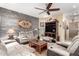 Spacious living room with ceiling fan, rustic wood accent wall, entertainment center, and comfortable seating at 20962 W Thomas Rd, Buckeye, AZ 85396