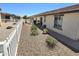 View of the backyard with gravel and decorative white picket fence at 2101 S Meridian Rd # 199, Apache Junction, AZ 85120