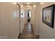 Clean hallway featuring hard surface floors, neutral walls, white trim, and artwork at 2101 S Meridian Rd # 199, Apache Junction, AZ 85120