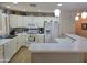 Well-lit kitchen featuring white cabinetry, breakfast bar, modern appliances, and decorative accents at 2101 S Meridian Rd # 199, Apache Junction, AZ 85120