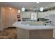 Bright kitchen featuring a breakfast bar, white cabinetry, tiled backsplash, and modern appliances at 2101 S Meridian Rd # 199, Apache Junction, AZ 85120
